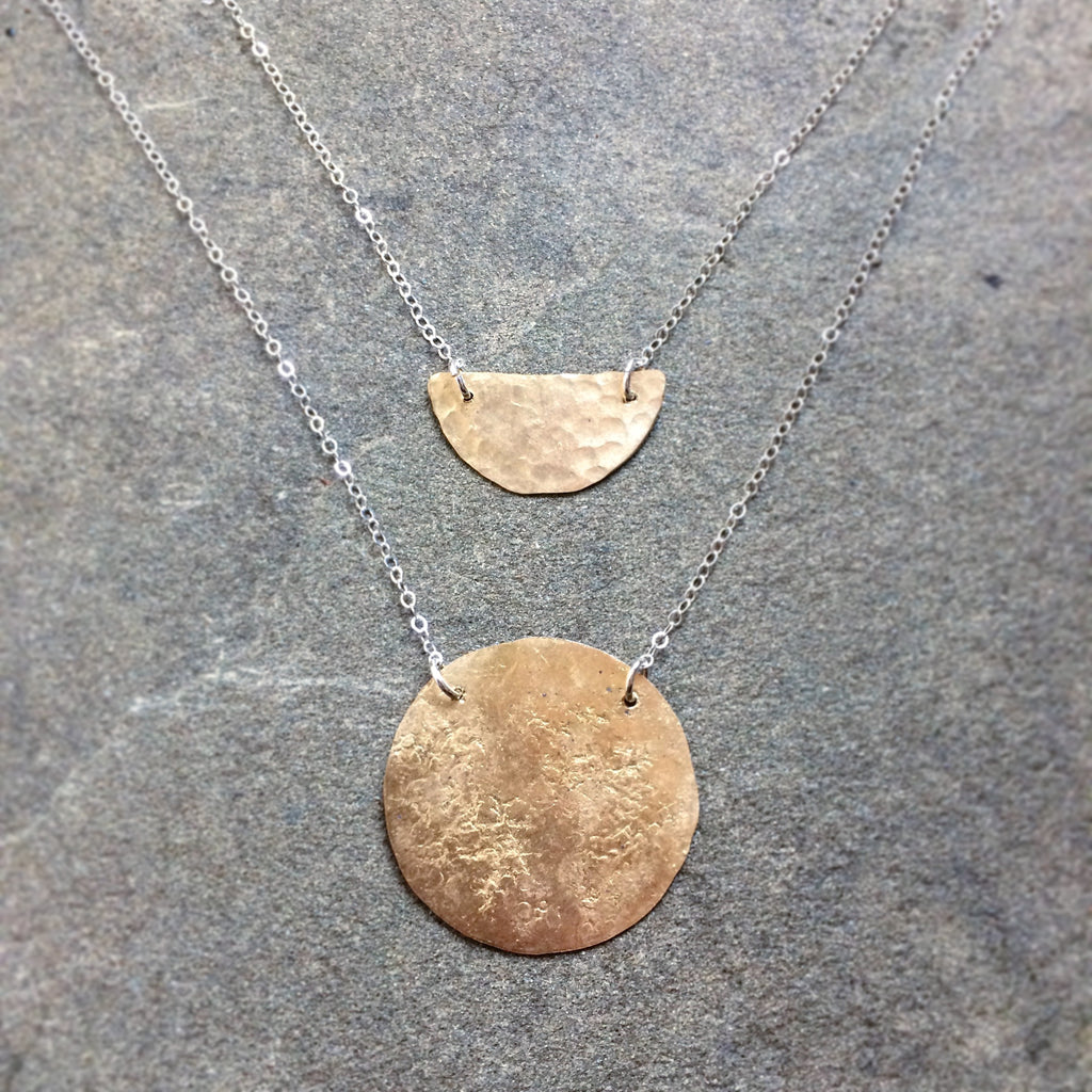 Solid brass moon and small pebbled brass moon, both floating on sterling silver chain. 